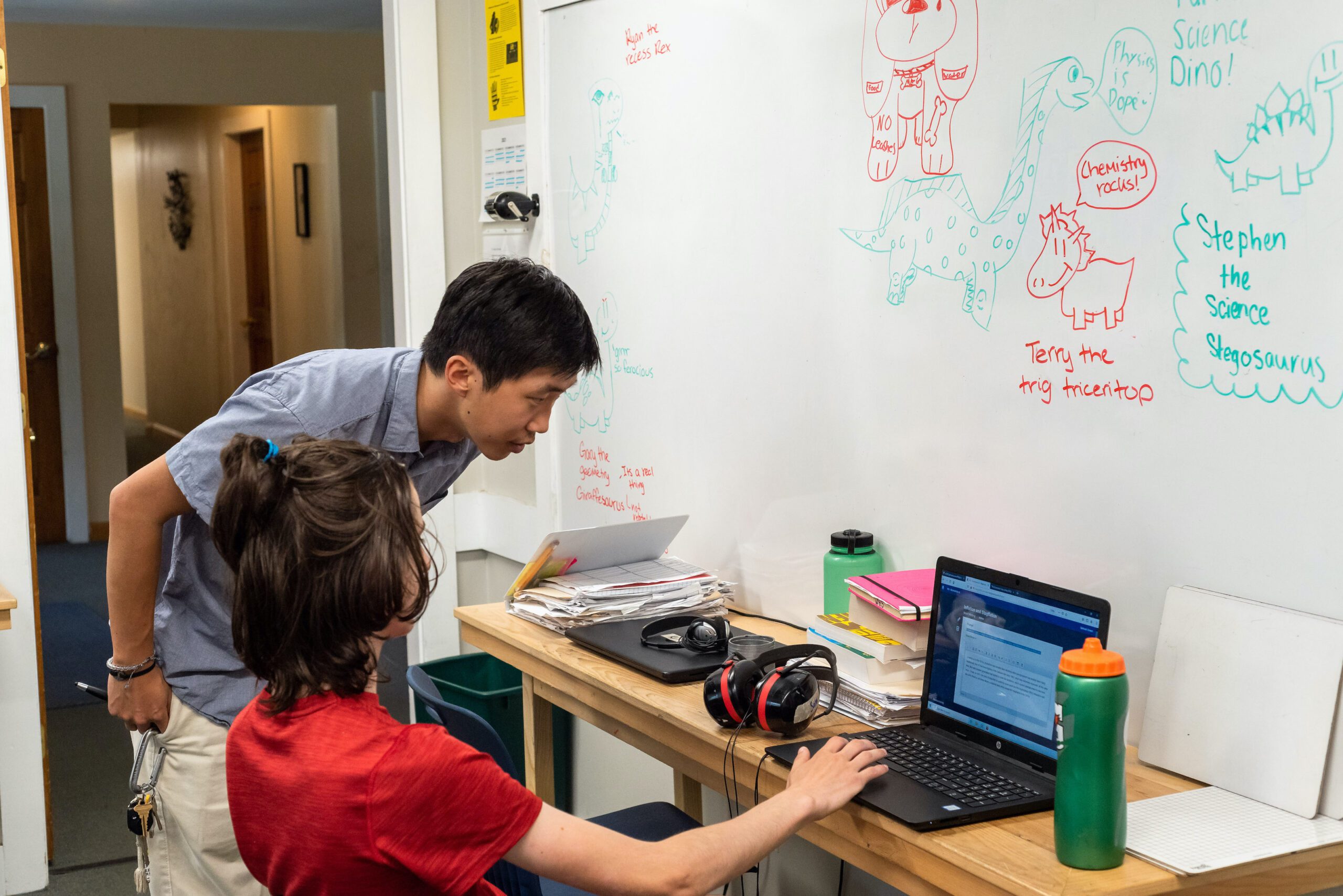 DSC_1345 Summit Acheivement teacher helping a student working on a laptop
