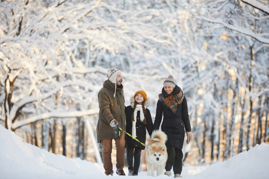 Happy Family Walking Dog in winter